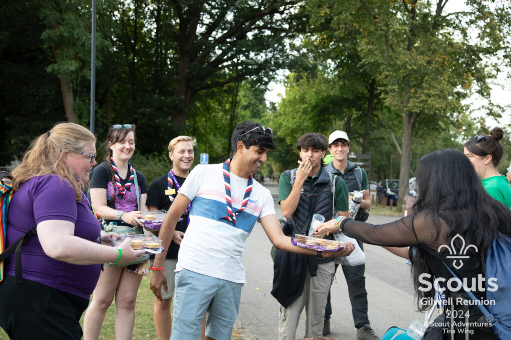 Friends sharing biscuits with passers by