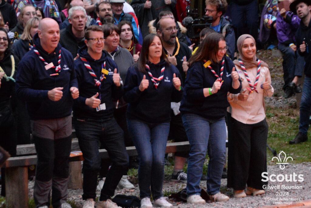 Some volunteers standing with their thumbs up