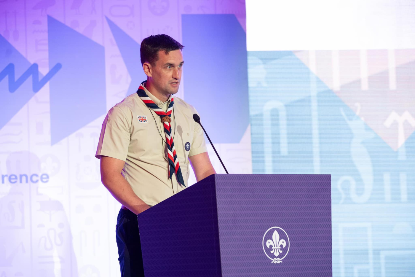 A scout leader delivers a speech at a podium